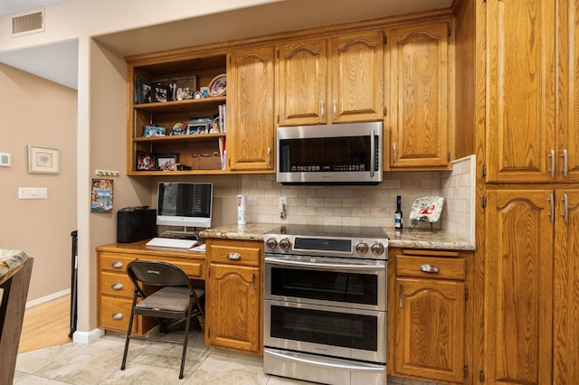 kitchen with decorative backsplash, brown cabinetry, visible vents, and appliances with stainless steel finishes