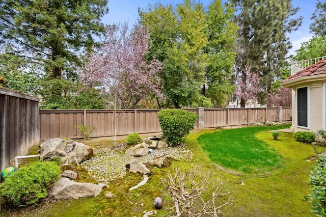 view of yard with a fenced backyard