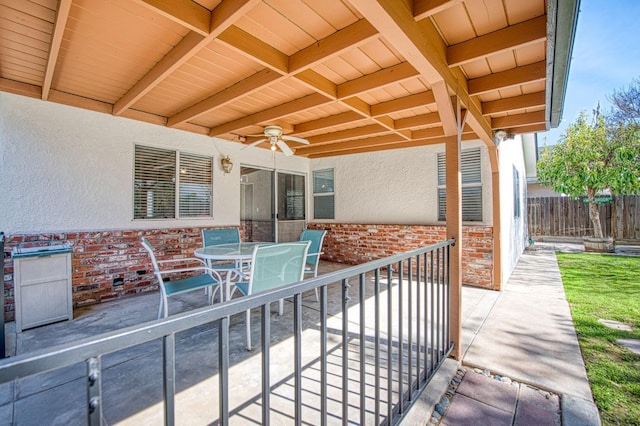 view of patio / terrace featuring outdoor dining space, ceiling fan, and fence