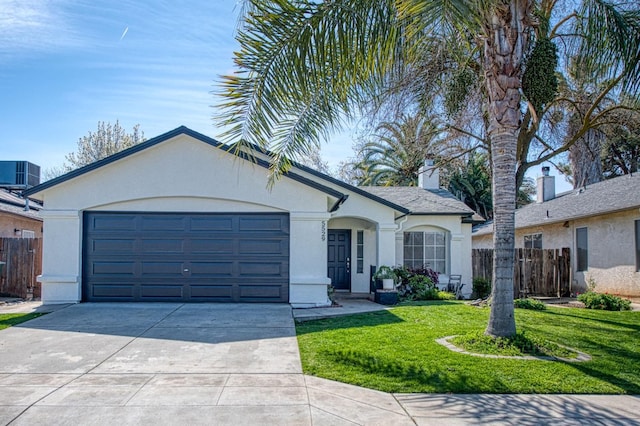 ranch-style home with an attached garage, fence, and stucco siding