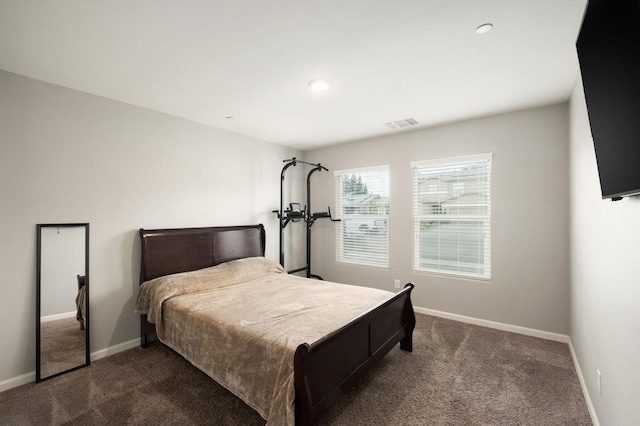 bedroom with visible vents, baseboards, and dark carpet