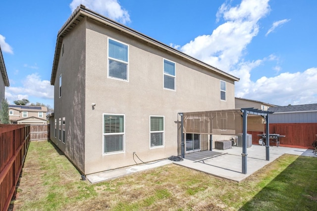 rear view of house with a patio area, a lawn, stucco siding, and a pergola