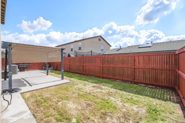 view of yard featuring a patio area, central AC unit, and a fenced backyard