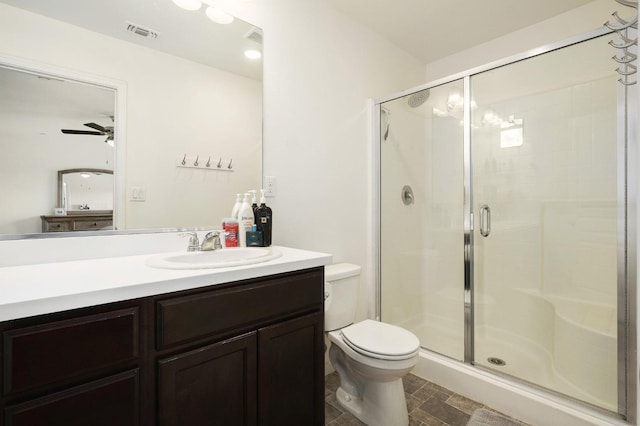 bathroom featuring visible vents, toilet, a stall shower, and vanity