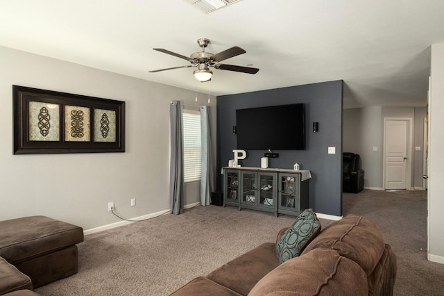 living area featuring visible vents, carpet floors, baseboards, and ceiling fan