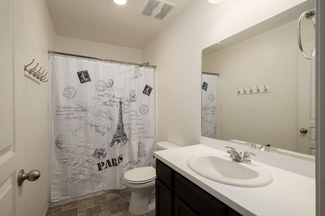 bathroom with visible vents, curtained shower, toilet, stone finish floor, and vanity