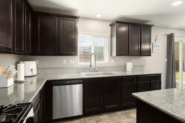 kitchen featuring dark brown cabinets, light stone countertops, recessed lighting, stainless steel appliances, and a sink