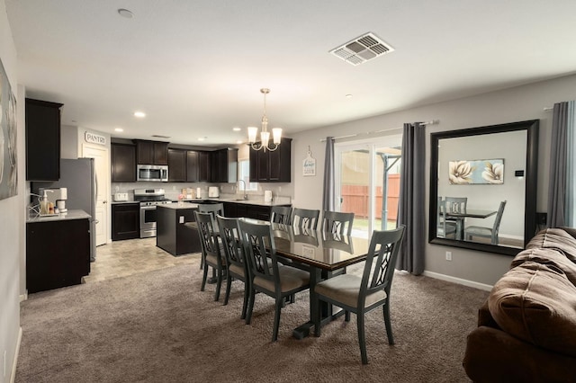 dining room featuring baseboards, visible vents, recessed lighting, light colored carpet, and a chandelier