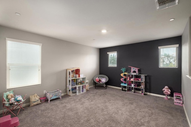 game room featuring a wealth of natural light, visible vents, baseboards, and carpet floors