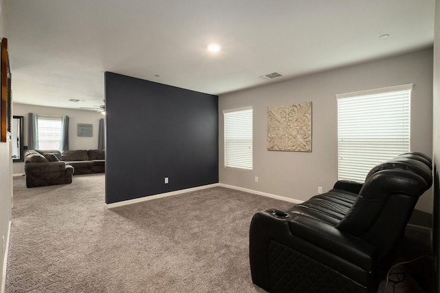 living area featuring carpet flooring, baseboards, and visible vents