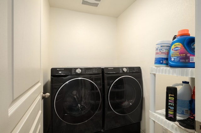 laundry room with visible vents, laundry area, and washing machine and clothes dryer