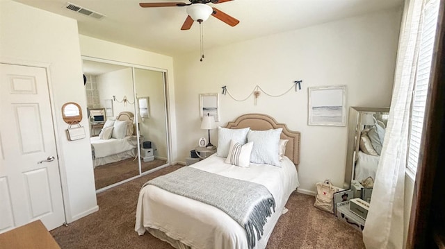 bedroom featuring a closet, visible vents, a ceiling fan, and carpet