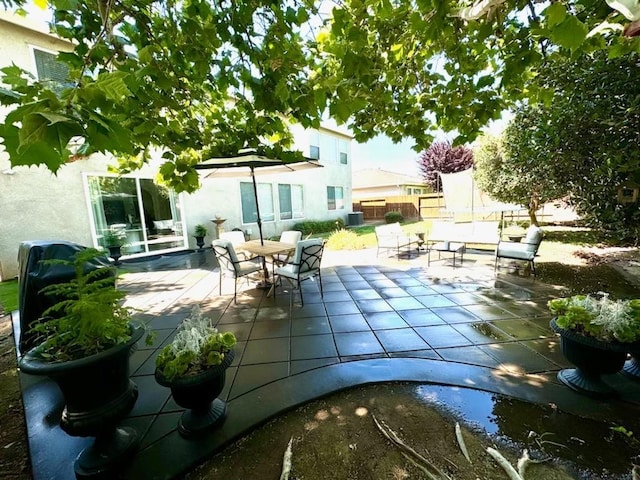 view of patio / terrace featuring outdoor dining space and fence