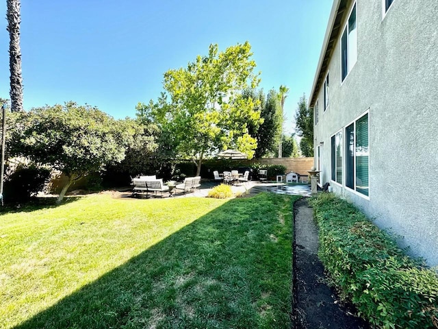 view of yard featuring fence private yard and a patio area