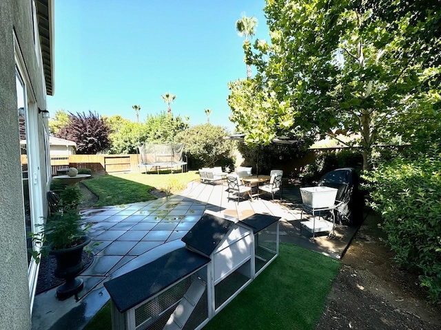 view of patio / terrace featuring a trampoline and a fenced backyard