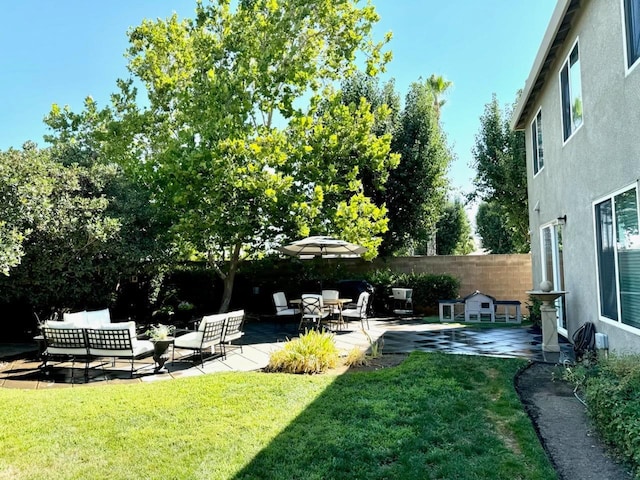 view of yard with outdoor lounge area, a patio, and fence