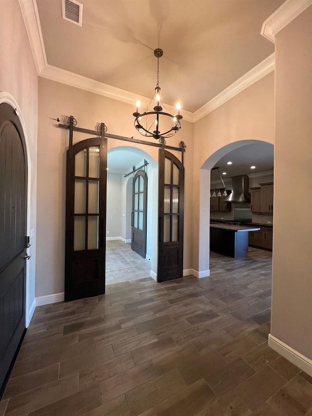 interior space featuring arched walkways, visible vents, and wood finish floors