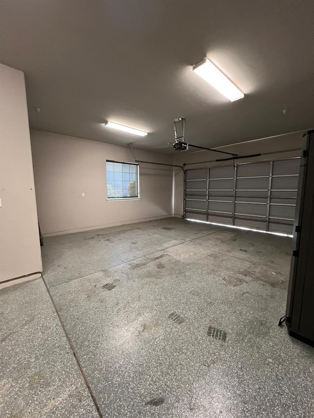 garage with a garage door opener and baseboards