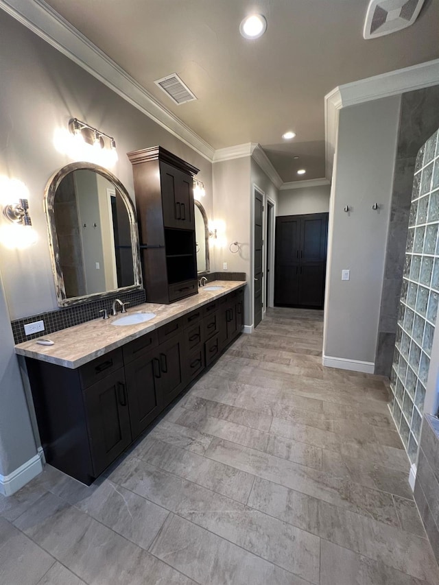 bathroom with double vanity, visible vents, and a sink