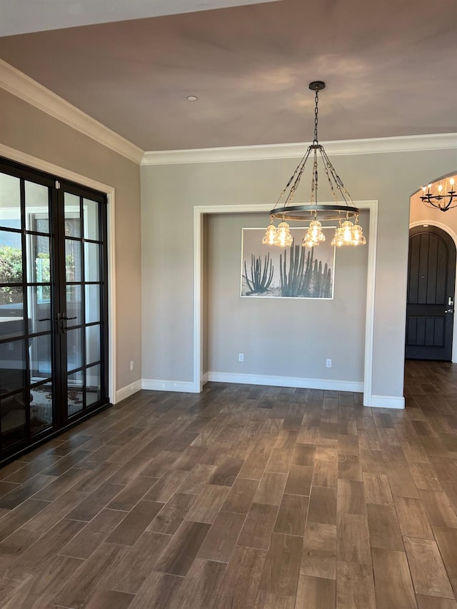 unfurnished room featuring crown molding, baseboards, french doors, an inviting chandelier, and dark wood-style floors