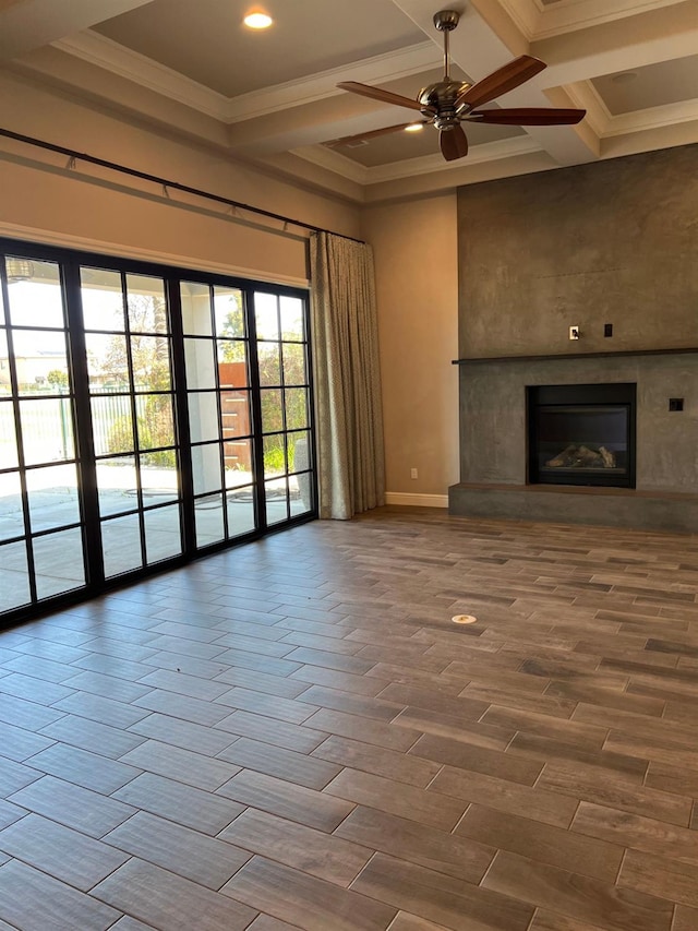 unfurnished living room with baseboards, coffered ceiling, wood finish floors, a fireplace, and ornamental molding