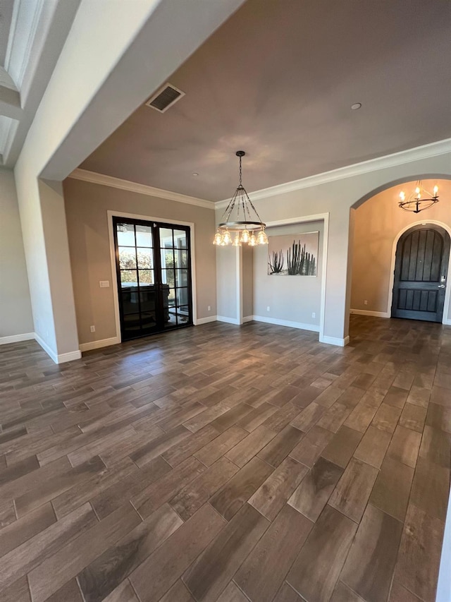 unfurnished dining area with visible vents, wood tiled floor, french doors, arched walkways, and a notable chandelier