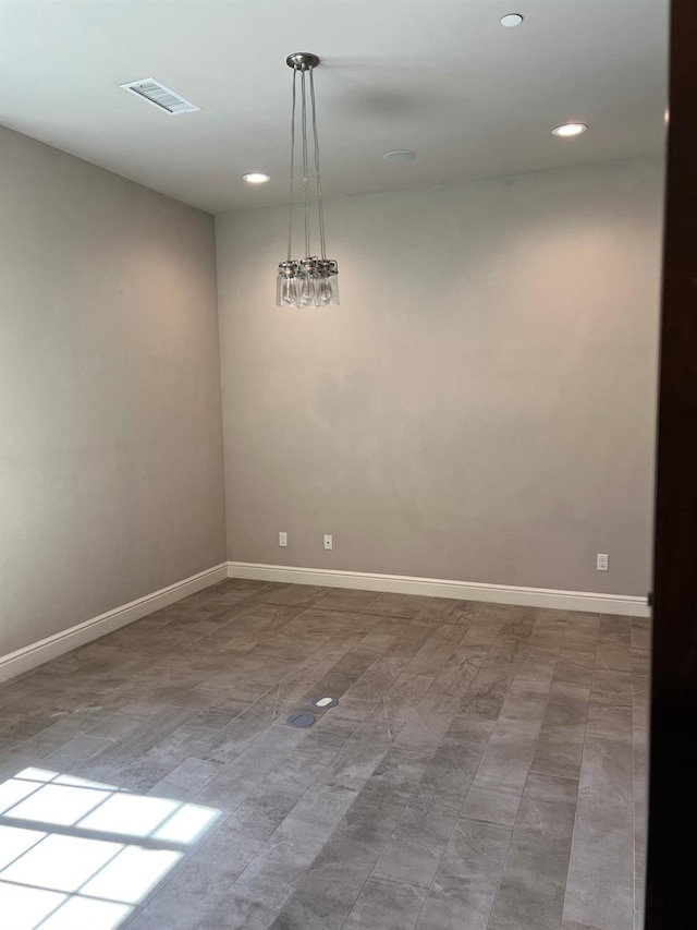 empty room featuring recessed lighting, visible vents, and baseboards