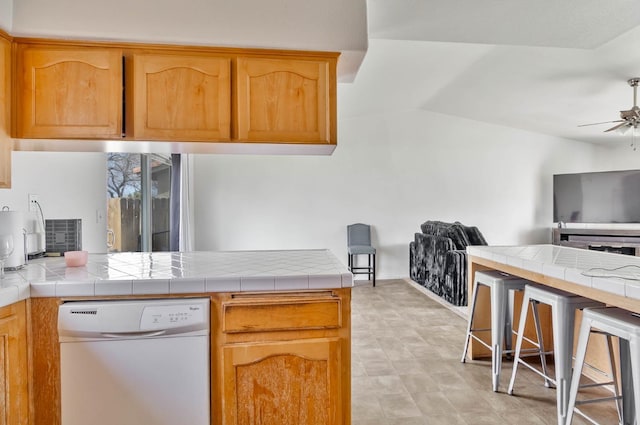 kitchen featuring a peninsula, white dishwasher, ceiling fan, vaulted ceiling, and open floor plan