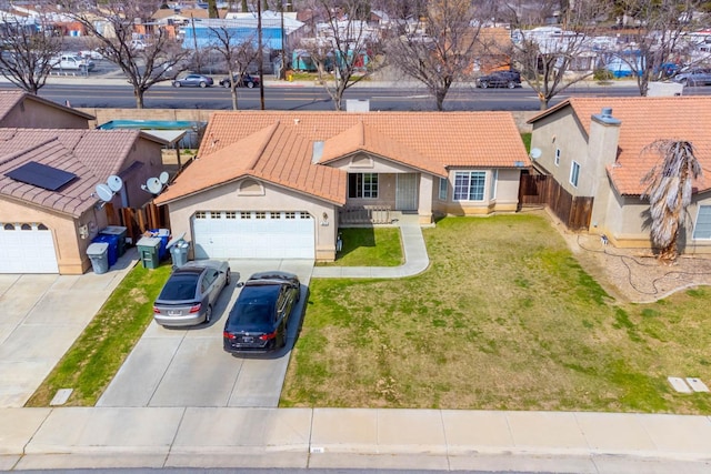view of front of house with a tiled roof, stucco siding, an attached garage, and concrete driveway