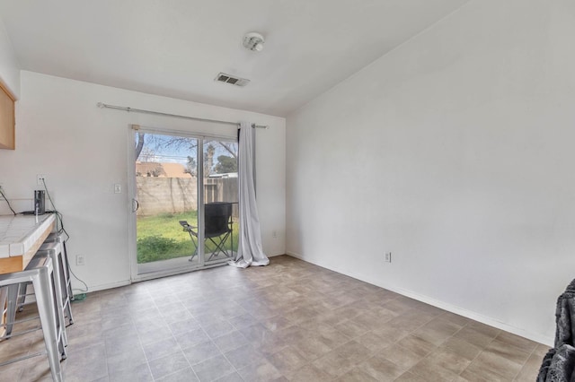 unfurnished dining area featuring baseboards