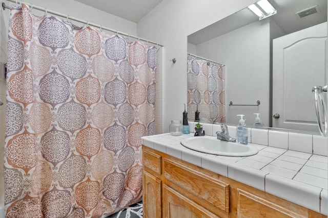 bathroom with vanity and visible vents