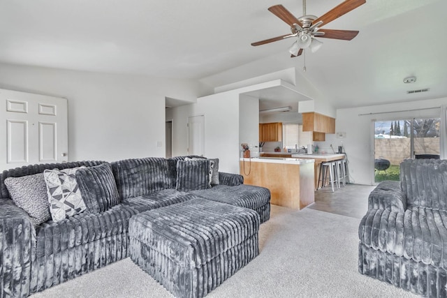 living room featuring ceiling fan, lofted ceiling, visible vents, and light carpet