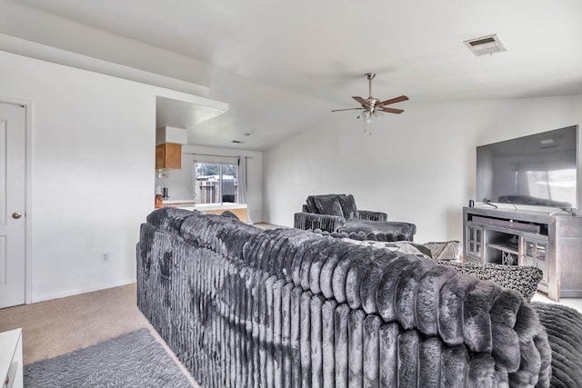 living room with vaulted ceiling, visible vents, carpet floors, and ceiling fan