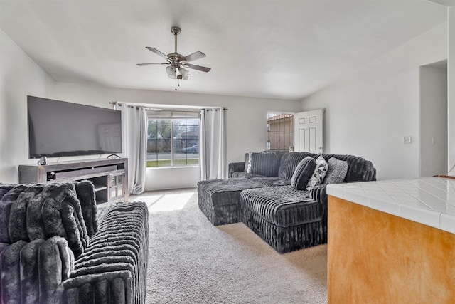 living area featuring light colored carpet and ceiling fan