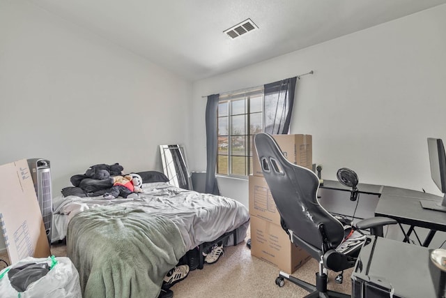 bedroom with speckled floor and a desk