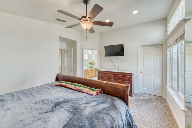 bedroom featuring a ceiling fan, ensuite bath, recessed lighting, baseboards, and light colored carpet