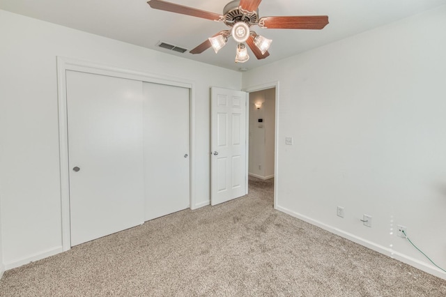 unfurnished bedroom featuring visible vents, a ceiling fan, a closet, carpet floors, and baseboards