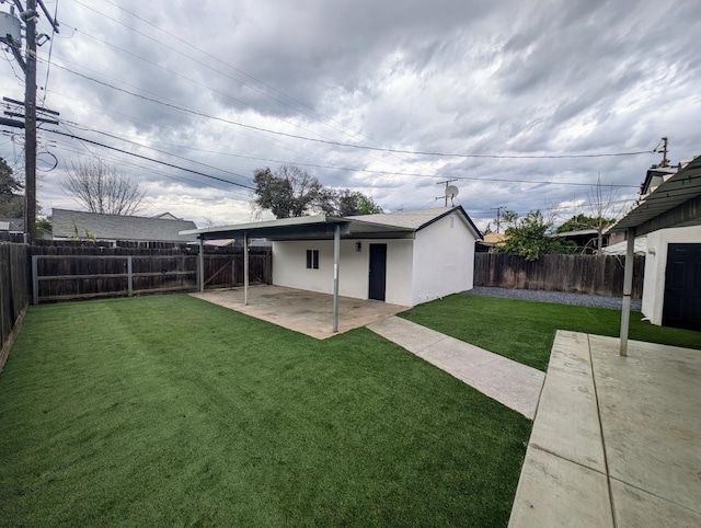 back of property with a yard, a fenced backyard, stucco siding, and a patio area