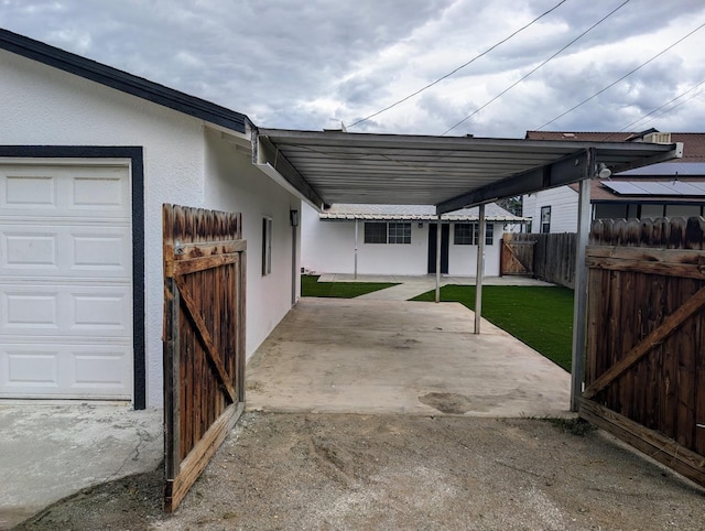 view of patio featuring a garage and fence