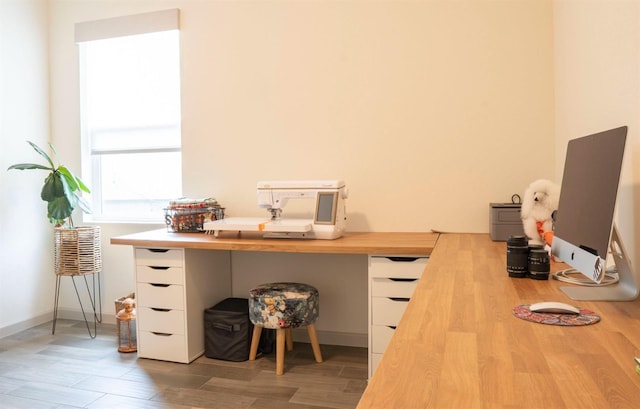home office with light wood finished floors and baseboards