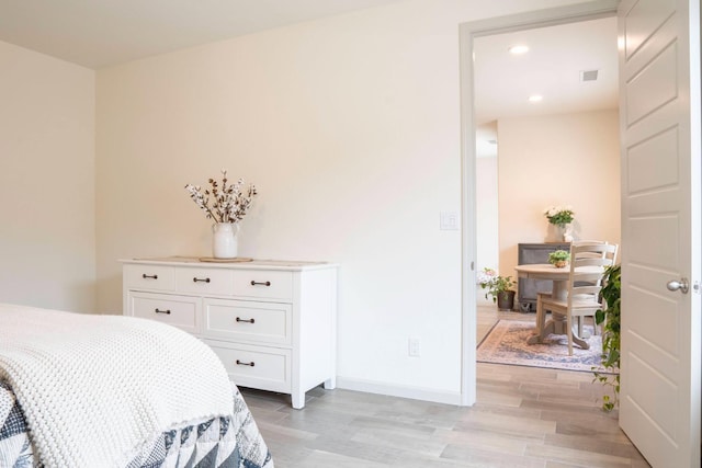 bedroom with recessed lighting, light wood-type flooring, baseboards, and visible vents