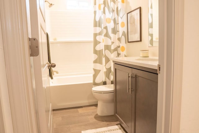 full bathroom with shower / bath combo with shower curtain, toilet, wood finished floors, and vanity