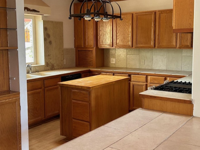 kitchen with backsplash, butcher block counters, and a sink