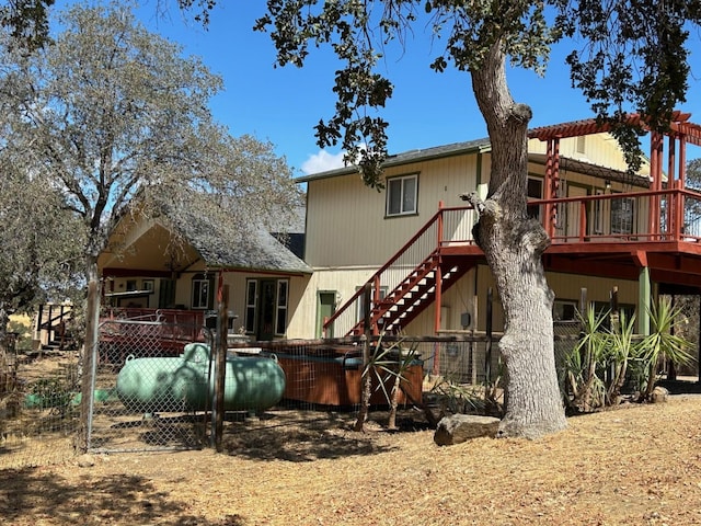 back of house featuring a deck and stairs