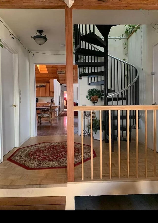 staircase featuring parquet floors