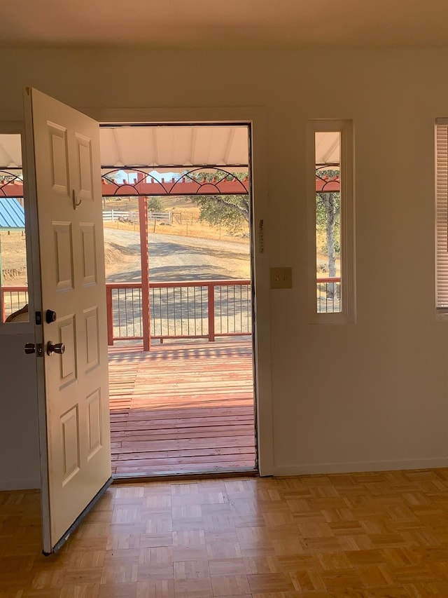 doorway featuring baseboards