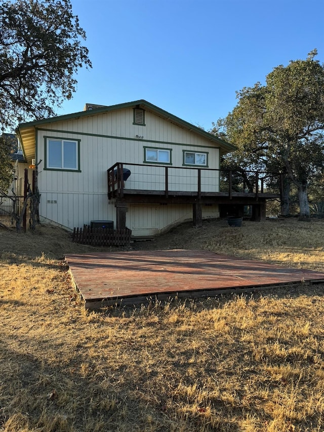 back of property featuring a wooden deck