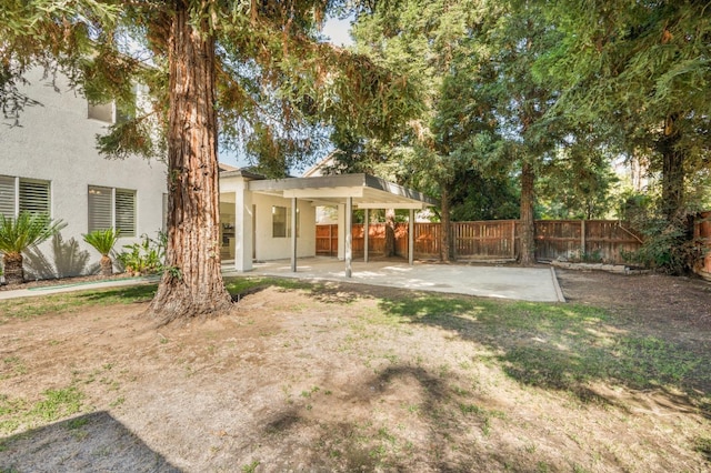 view of yard featuring a patio and fence