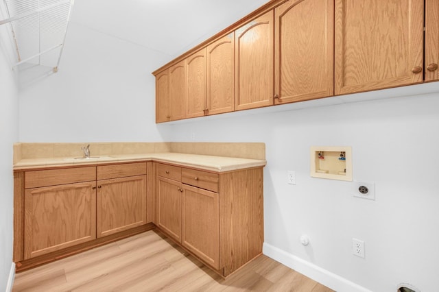 clothes washing area with baseboards, washer hookup, light wood-style flooring, cabinet space, and hookup for an electric dryer