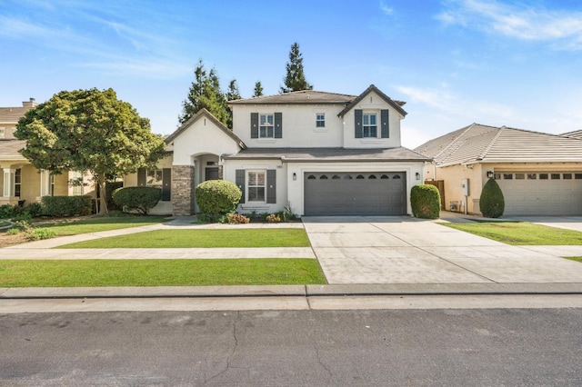 traditional home with stucco siding, driveway, an attached garage, and a front lawn